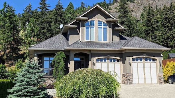 A two-story house with a prominent gable roof, a large bay window, and a garage. - Spacious Westside  Wine Trail Retreat ★★★★★ (West Kelowna)