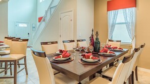Enjoy meals in this inviting dining area with a long table and comfortable seating.