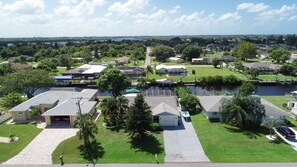 Stunning homes surround a serene neighborhood with a communal pool and waterfront access.