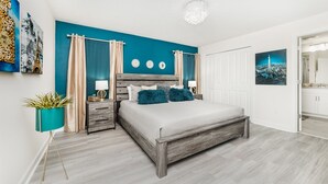 A bedroom with a bed, nightstands, a potted plant, and a view of the bathroom. - Beautiful 5 Star Townhome on Storey Lake Resort with Private Pool, Orlando Townhome 5020 (Orlando)