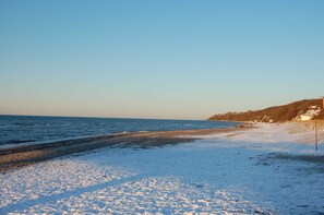 A beach with a sandy shore and a clear sky.