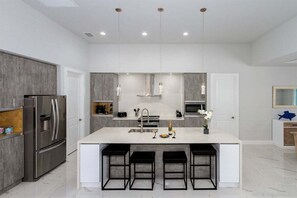 Fridge, microwave, oven, stovetop - Coral Pearl- Modern New Construction Vacation Home (Cape Coral)