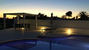 A swimming pool with tiled flooring, lounge chairs, and a covered seating area with tables and chairs. - 3min. Walk to the beach, Villa Bini  Perla, sea view, sunny, quiet location (Binibequer)