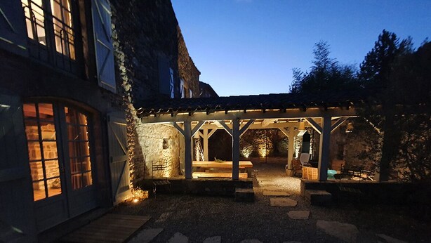 A courtyard with a wooden pergola, stone walls, and a bench. - calm and nature, with private pool (vindrac-alayrac)
