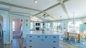 A spacious kitchen with a large island, white cabinetry, and a ceiling fan. - Beaulieu-Sur-Duck - Sanderling, Ocean View, Steps to Direct Boardwalk, Pets OK, Flex Stays (Duck)