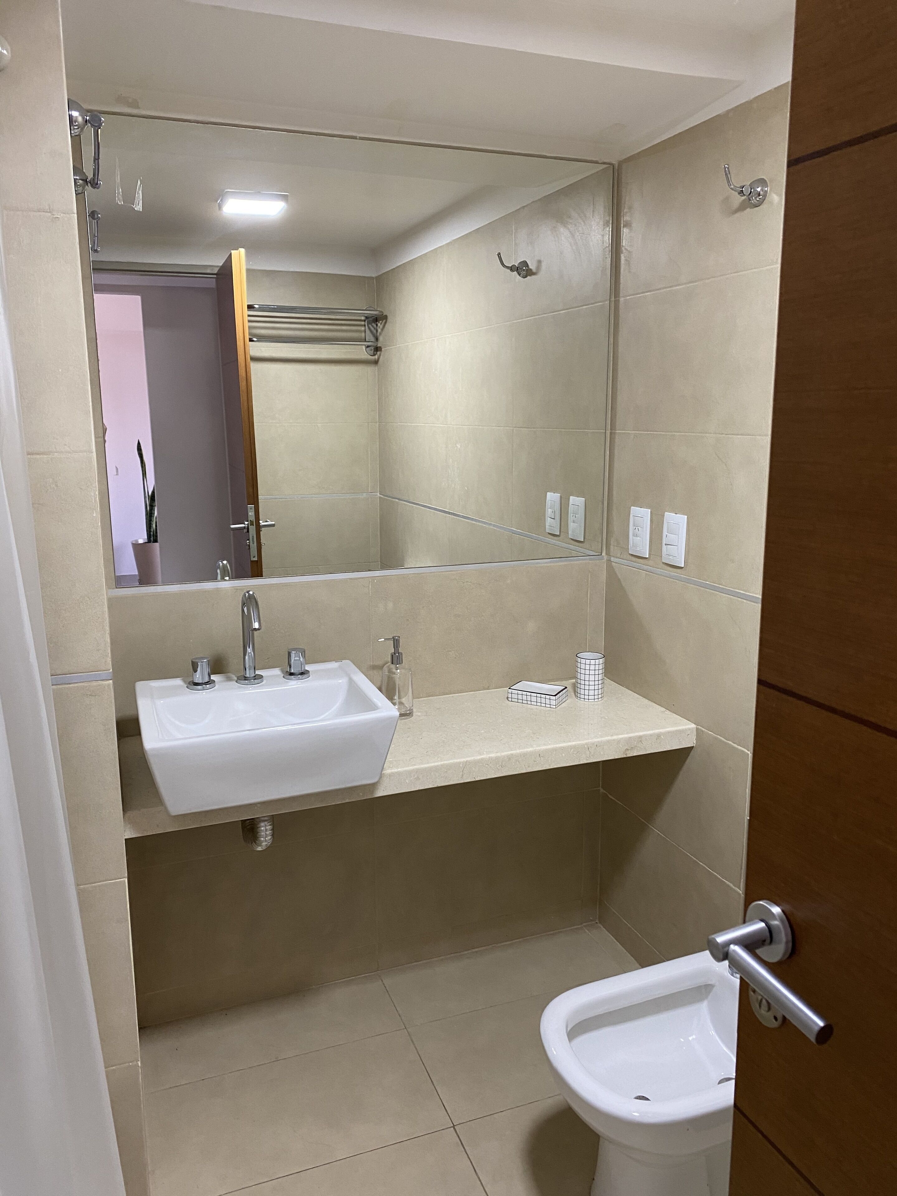 Un bagno con lavandino, specchio e bidet.