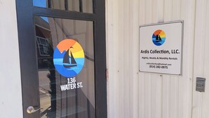 A door with a sign for Ardis Collection, LLC. offering nightly, weekly, and monthly rentals. - Downtown Studio at The Lake -Unit 4 (Conneaut Lake)