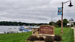 A sign for Ice House Park with a view of boats on the water and a cloudy sky. - Downtown Studio at The Lake -Unit 4 (Conneaut Lake)