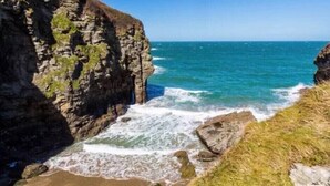 A coastal landscape with cliffs and waves. - Sea views just yards from restaurants, pubs & shops. Sleeps 16-18, 8 x en-suite. (Tintagel)