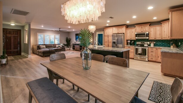 A spacious kitchen with wooden cabinets, a large island, and a chandelier. - Relaxing 4 Bdrm Retreat in the Heart of Scottsdale!  Big yard and Heated Pool!  (Scottsdale)