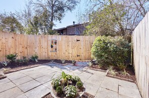 Enjoy a serene outdoor space with a patio, garden, and lush greenery.