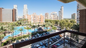 A hotel with a pool area, multiple parking levels, and a view of surrounding high-rise buildings. - AQUARIUM II 8-3 (Benidorm)