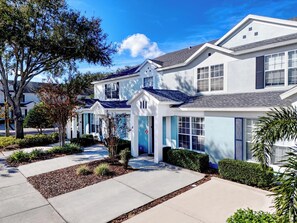 A row of modern, two-story houses with a uniform architectural style, featuring large windows and a flat roof.