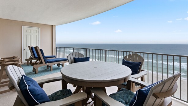 A balcony with a view of the ocean, furnished with chairs and a table. - Regency Isle 904 by Liquid Life (Orange Beach)