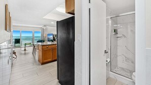 A modern bathroom with a glass shower, a toilet, and a sink. - Gorgeous Oceanside Oasis w/ Heated Pool, Oceanfront Patio & Steps to the Beach 🏖️☀️ (Satellite Beach)