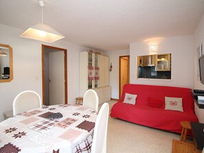 Cozy living space with a dining area, sofa, and TV.