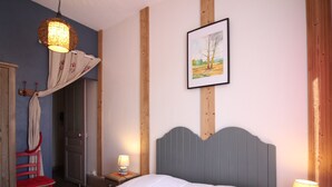 A bedroom with a bed, a nightstand, a lamp, a chair, a wardrobe, and a painting on the wall.