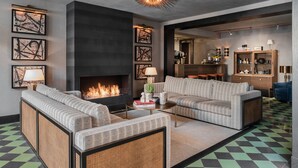 A modern living room with a fireplace, sofas, and a patterned floor. - Root Karaköy Bosphorus Hotel & Spa (Istanbul)