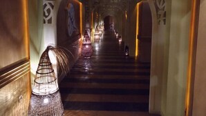 A corridor with a staircase, decorative wall panels, and hanging lamps. - Hotel Royal Beach 5 Premium - Central Sea View G6 (Sunny Beach)
