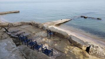 On the beach, sun-loungers