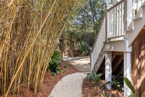 Stroll through lush gardens to a charming country-style retreat.