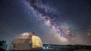 A geodesic dome structure with a clear view of the Milky Way.