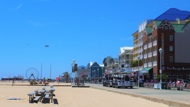 A beachside boardwalk with shops, a Ferris wheel, and a tram. - On Main Street - Apartment C  - Berlin, MD (Berlin)