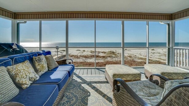 A covered outdoor seating area with a view of the beach. - Spacious Gulf Front Home on Extra Wide Lot! (Port St. Joe)