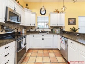 Enjoy cooking in this well-equipped kitchen with a microwave, oven, and sink.