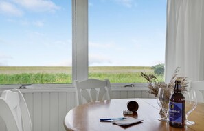 A dining table with a bottle of wine, a pen, and dice. - 1 bedroom beautiful home in Løgstør (Løgstør)
