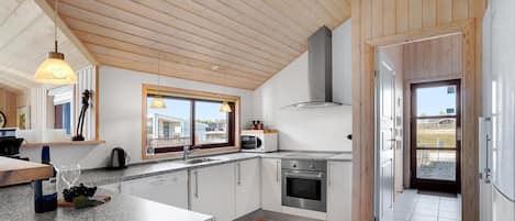 Fridge, stovetop, dishwasher, coffee/tea maker