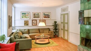 A living room with a sofa set, a coffee table, a lamp, and a fireplace. - Nice home in Gusum with lake view (Gusum)