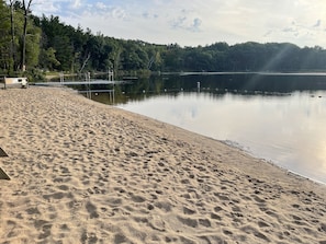 A sandy beach with a calm lake, surrounded by trees. - Private,backyard BBQ,campfire, kayak,fish,Wis Dells,UTV,hike,winery,swim,pets, (Oxford)