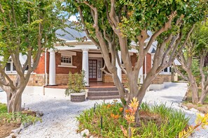 A house with a front porch, white columns, and a stone facade.
