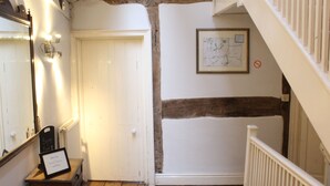 A hallway with a white door, a framed map on the wall, and a staircase with a white railing. - 4bedhouse/leominster/hiking/castles/sleeps7/wifi (Leominster)