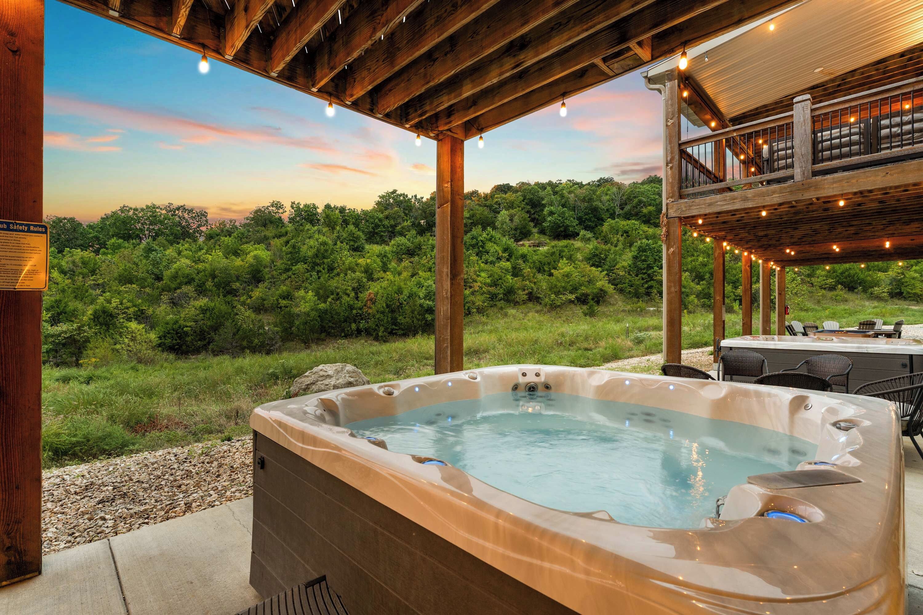 Ein Whirlpool mit einer Holzterrasse und Blick auf ein bewaldetes Gebiet.
