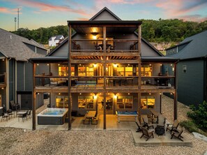 A multi-story building with a covered outdoor area, a hot tub, and outdoor seating. - Table Rock Lake View! Two Community Pools! (Branson)