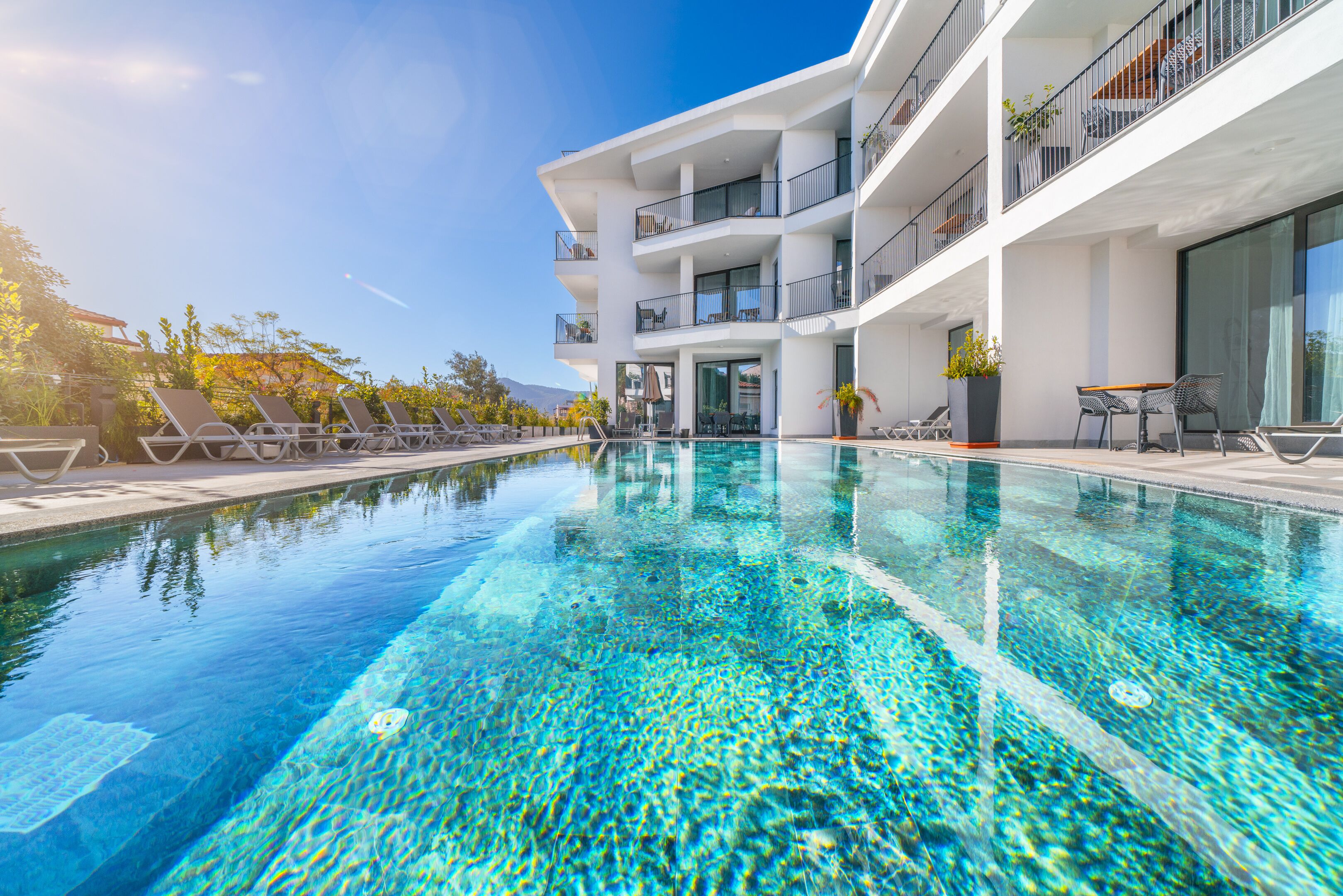 seasonal outdoor pool, pool umbrellas, pool loungers