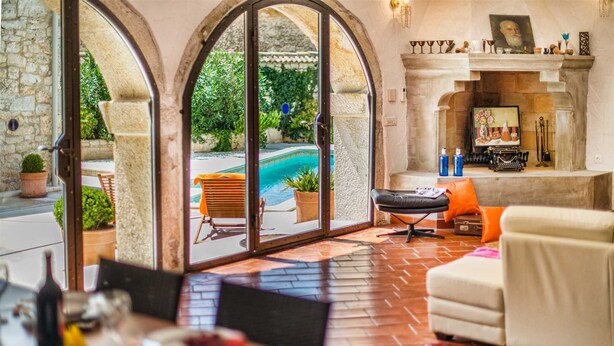 A spacious living area with a pool view, a fireplace, and a comfortable seating arrangement. - Villa Marko (Vrsar)