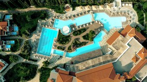 An aerial view of a resort with a large swimming pool, multiple guest buildings, and landscaped areas. - Zeus Eretria Resort  (Eretria)