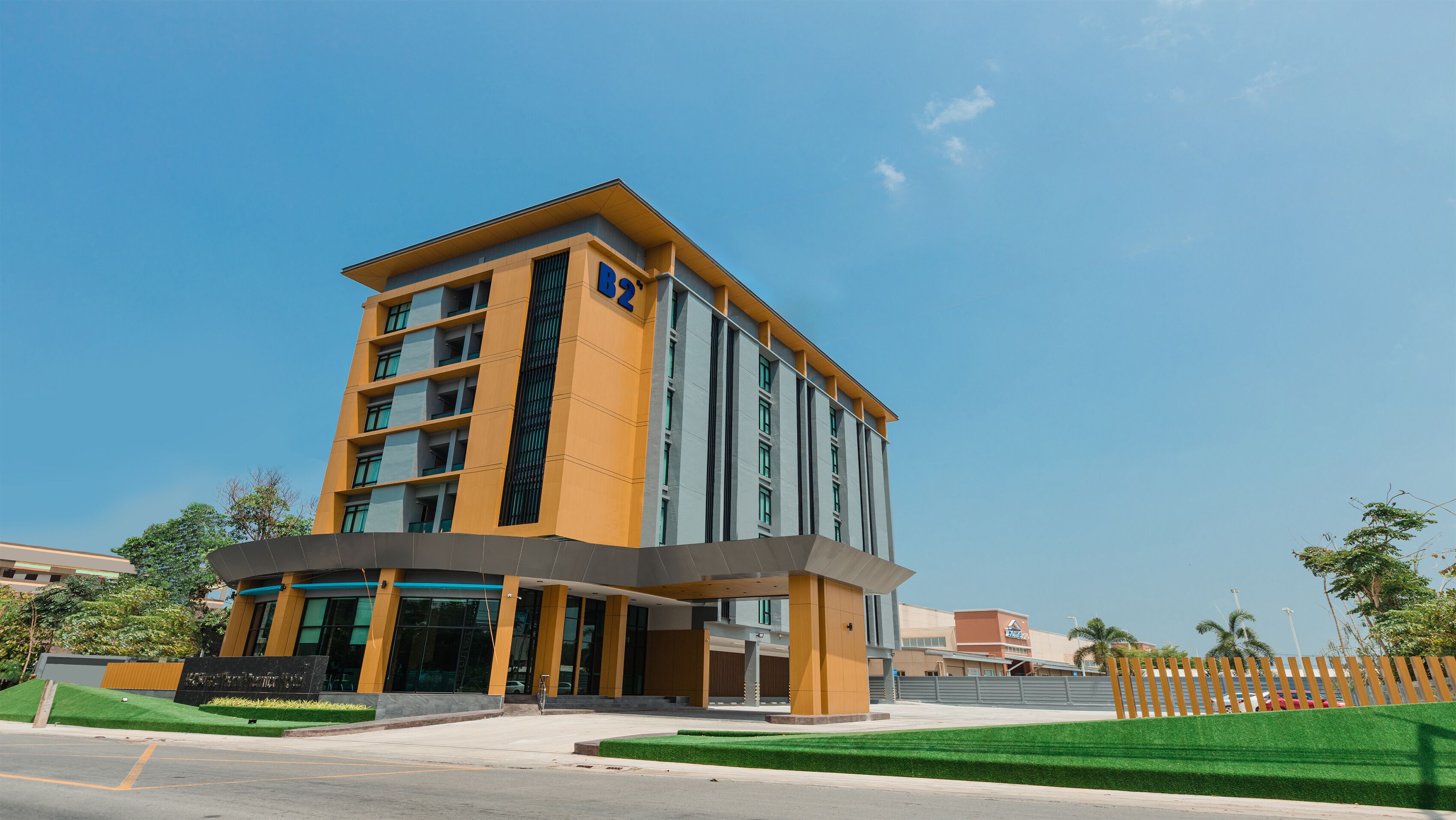 A modern building with a flat roof, large windows, and a prominent entrance.