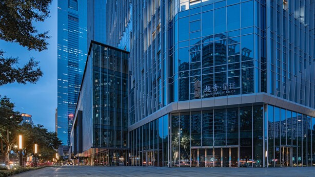 A modern building with reflective glass windows and a prominent entrance. - Star Residence ICC Guangzhou (Guangzhou)