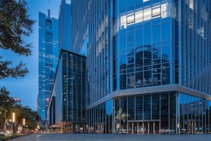 A modern building with reflective glass windows and a prominent entrance. - Star Residence ICC Guangzhou (Guangzhou)