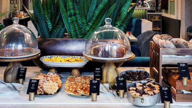 A breakfast buffet with various food items and a decorative ceiling with circular lights. - Radisson Collection Hotel, Palazzo Nani Venice (Venice)