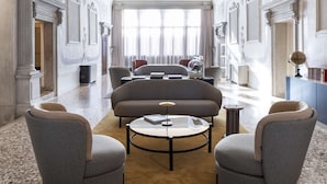 A luxurious room with a grand chandelier, elegant furniture, and a large circular ceiling artwork. - Radisson Collection Hotel, Palazzo Nani Venice (Venice)