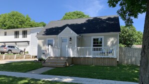 A single-story house with a front porch, a mailbox, and a visible address number.