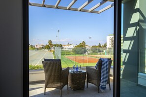 Enjoy the view of the nearby baseball field from this balcony, perfect for relaxation and socializing.