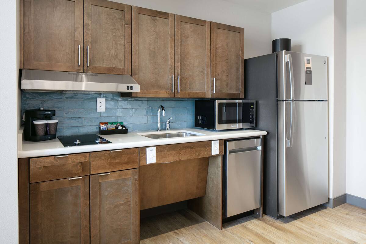 studio, 1 king bed, accessible, bathtub (mobility & hearing) | private kitchen | full-sized fridge, microwave, stovetop, dishwasher