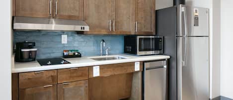 A modern kitchen with wooden cabinets, stainless steel appliances, and a dishwasher.