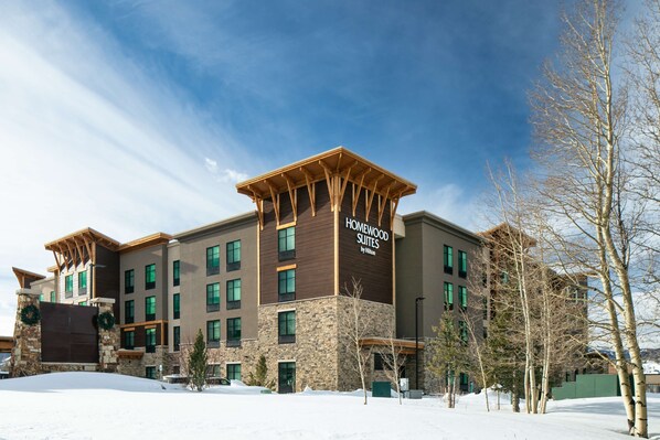 A multi-story hotel with a stone facade and wooden accents, featuring a sign that reads "Homewood Suites by Hilton." - Homewood Suites by Hilton Dillon (Dillon)
